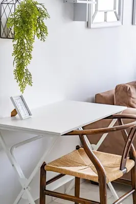 a white desk with a chair and a plant at Willow House Oasis - Your Haven in Kempton Park