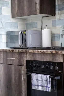 a microwave sitting on top of a kitchen counter at Willow House Oasis - Your Haven in Kempton Park