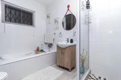 a bathroom with a tub and a sink and a shower at Willow House Oasis - Your Haven in Kempton Park