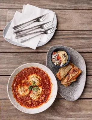 a table with a plate of food and a bowl of food at The Blyde blue lagoon in Pretoria
