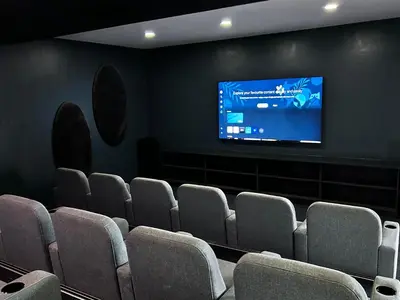 a cinema room with chairs and a flat screen tv at The Blyde blue lagoon in Pretoria