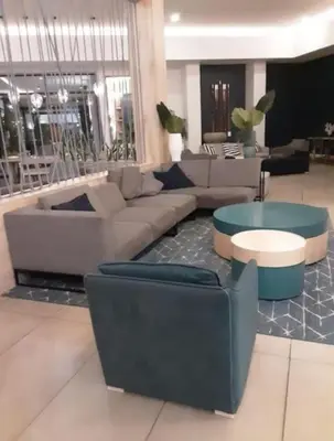a lobby with couches and tables in a building at The Blyde blue lagoon in Pretoria