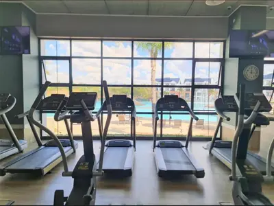 a gym with several tread machines in front of a window at The Blyde blue lagoon in Pretoria