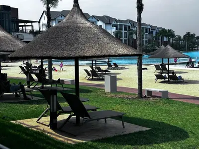a group of chairs and umbrellas on a beach at The Blyde blue lagoon in Pretoria