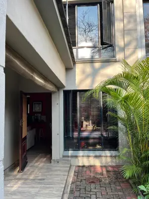 a house with a patio with a window at Nzwaki Self Catering in Nelspruit