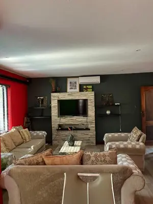 a living room with two couches and a television at Nzwaki Self Catering in Nelspruit