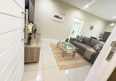 a living room with a couch and a table at Guestnest in Mokopane