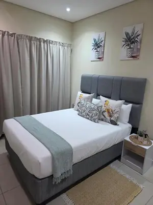 a bedroom with a large bed in a room at Guestnest in Mokopane