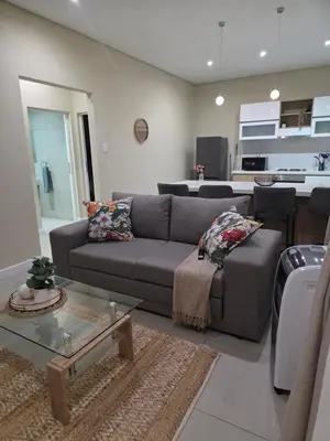 a living room with a couch and a table at Guestnest in Mokopane