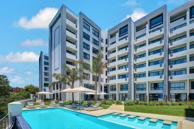 an image of an apartment building with a swimming pool at Stay Menlyn - Luxe Apartment 617 in Pretoria