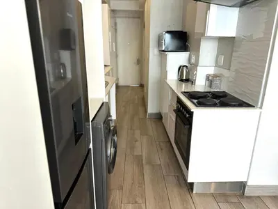 a kitchen with a stove and a counter top at Stay Menlyn - Luxe Apartment 617 in Pretoria