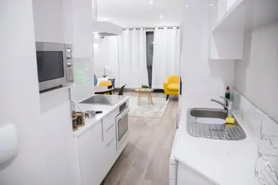 a white kitchen with a sink and a microwave at Stay Menlyn - Luxe Apartment 617 in Pretoria