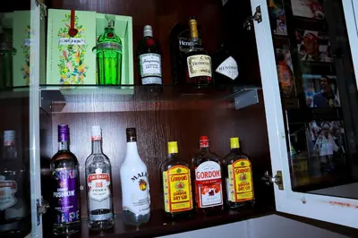 a shelf filled with lots of bottles of alcohol at Masai Shuttles And Hotel in Polokwane