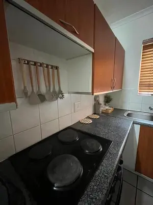 a kitchen with a stove top oven in a kitchen at Intsika apartments in Nelspruit
