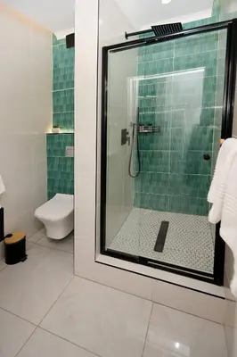 a bathroom with a glass shower with a toilet at Unit 203 at Glen Park in Pretoria
