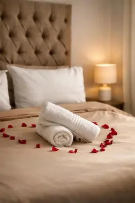 a towel on a bed with red hearts on it at La Dukes Resort in Bushman Rock