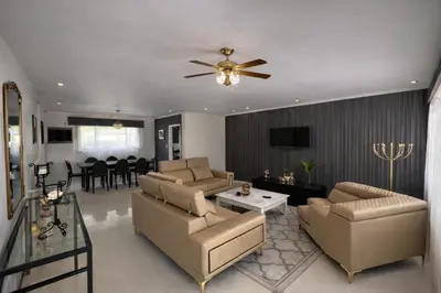 a living room with a couch and a ceiling fan at La Dukes Resort in Bushman Rock