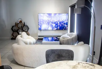 a living room with two chairs and a tv at Time Oon Travel And Tour Unit 754 Luxurious in Pretoria