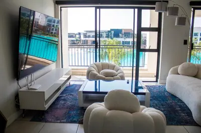 a living room with two chairs and a tv at Time Oon Travel And Tour Unit 754 Luxurious in Pretoria