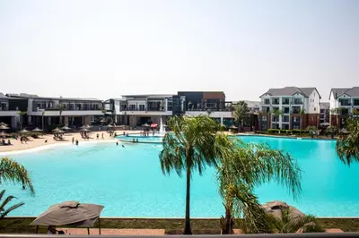 a large swimming pool with people on a beach at Time Oon Travel And Tour Unit 754 Luxurious in Pretoria