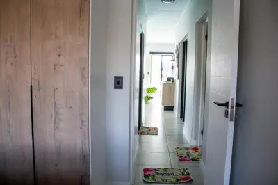 a hallway with a door and a floor with mats on the floor at Time Oon Travel And Tour Unit 754 Luxurious in Pretoria