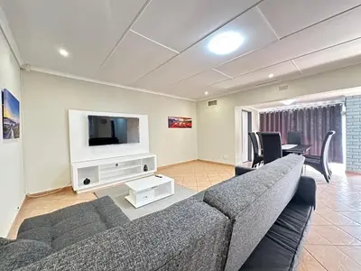 a living room with a couch and a tv at 3 Bedroom House in Nelspruit in Nelspruit
