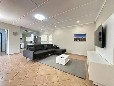 a living room with a couch and a table at 3 Bedroom House in Nelspruit in Nelspruit