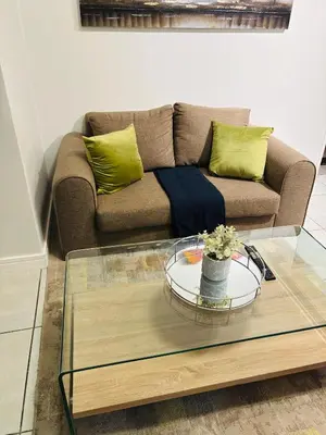 a living room with a couch and a glass table at The Blyde Blue Lagoon 1 in Pretoria