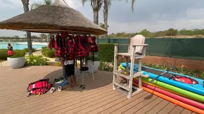 a deck with a gazebo with a surfboard and a chair at The Blyde Blue Lagoon 1 in Pretoria