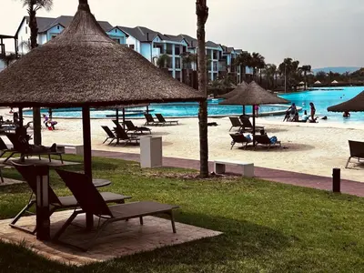 a group of chairs and umbrellas on a beach at The Blyde Blue Lagoon 1 in Pretoria