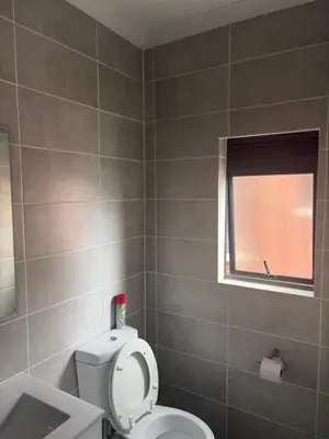 a bathroom with a toilet and a window at The Blyde Blue Lagoon 1 in Pretoria