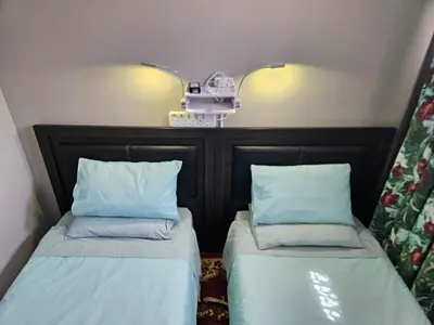 two beds sitting next to each other in a room at Luxury Meets Convenience Near City & Travel Links in Pretoria