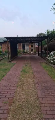 a brick path leading to a building with a pavilion at Stay at Wolkeberg in Middelburg