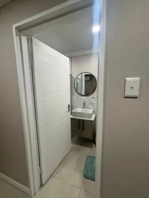 a bathroom with a sink and a mirror at Tranquil Stays in Polokwane