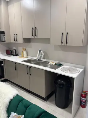 a kitchen with white cabinets and a sink at Tranquil Stays in Polokwane