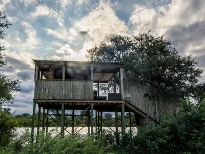 a building on a wooden stand in a field at Tintswalo Scops Rest in Klaserie Private Nature Reserve