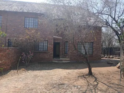 a brick house with a door in a yard at Maridadi House in Marloth Park