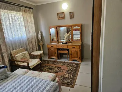 a bedroom with a dressing table and a mirror at Luxury Meets Convenience Near City & Travel Links in Pretoria