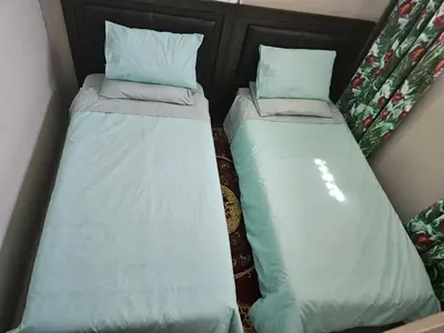 two beds sitting next to each other in a room at Luxury Meets Convenience Near City & Travel Links in Pretoria