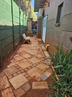 a patio with a bench next to a building at Luxury Meets Convenience Near City & Travel Links in Pretoria