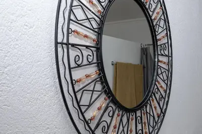 a mirror hanging on a wall with a towel at Mad Safari Bush Camp in Phalaborwa