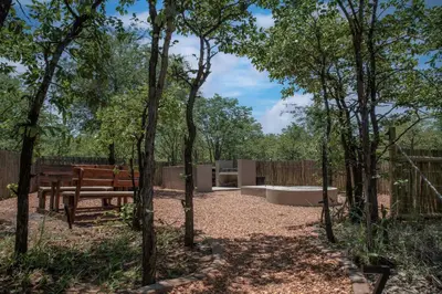 a park with a bench and a picnic table at Mad Safari Bush Camp in Phalaborwa