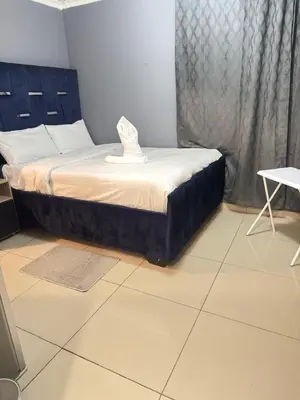 a bed with a hat on it in a room at The Light Guest House in Midrand