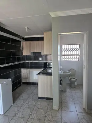 a kitchen with a sink and a toilet in it at House 224 Lodge in Driekop