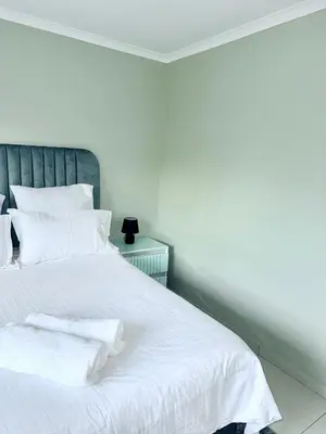 a white bed with two white towels on it at Country Farm House in Delmas