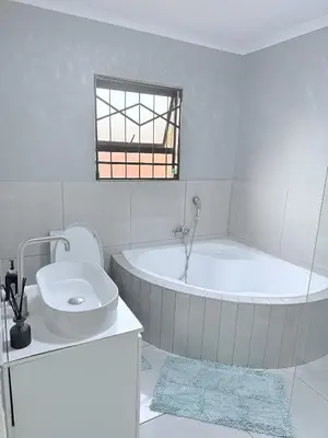 a white bathroom with a tub and a sink at Country Farm House in Delmas