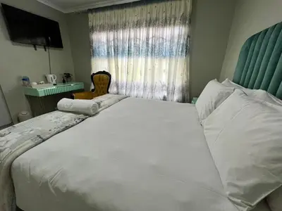 a large white bed in a room with a window at Country Farm House in Delmas