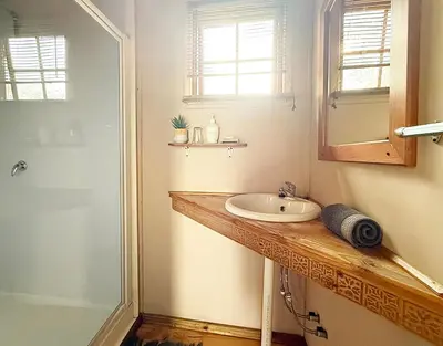 a bathroom with a sink and a shower at Leopard Chalets Hippo Waterfront Lodge in Nelspruit