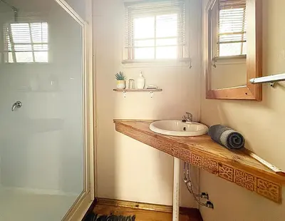 a bathroom with a sink and a shower at Leopard Chalets Hippo Waterfront Lodge in Nelspruit