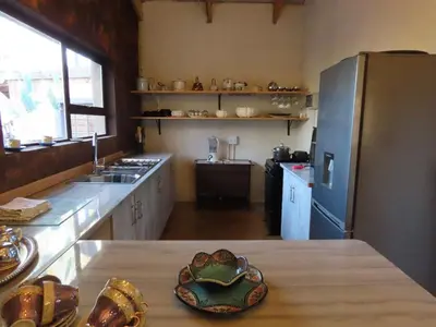 a kitchen with a table with a heart bowl on it at Unique Kruger Hide & Spa in Marloth Park